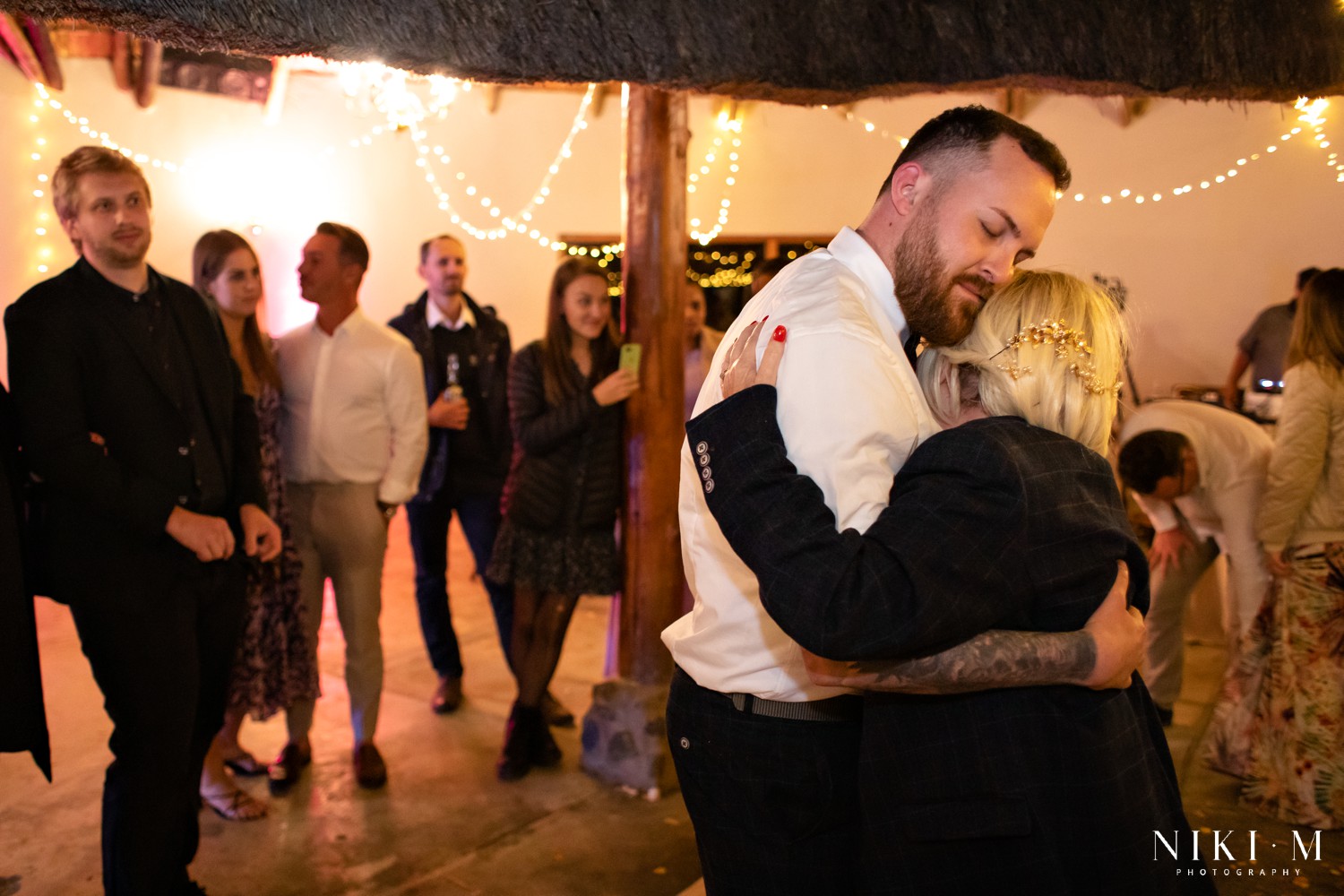 Brother and mother sharing a tender dance together during the reception at a Drakensberg wedding